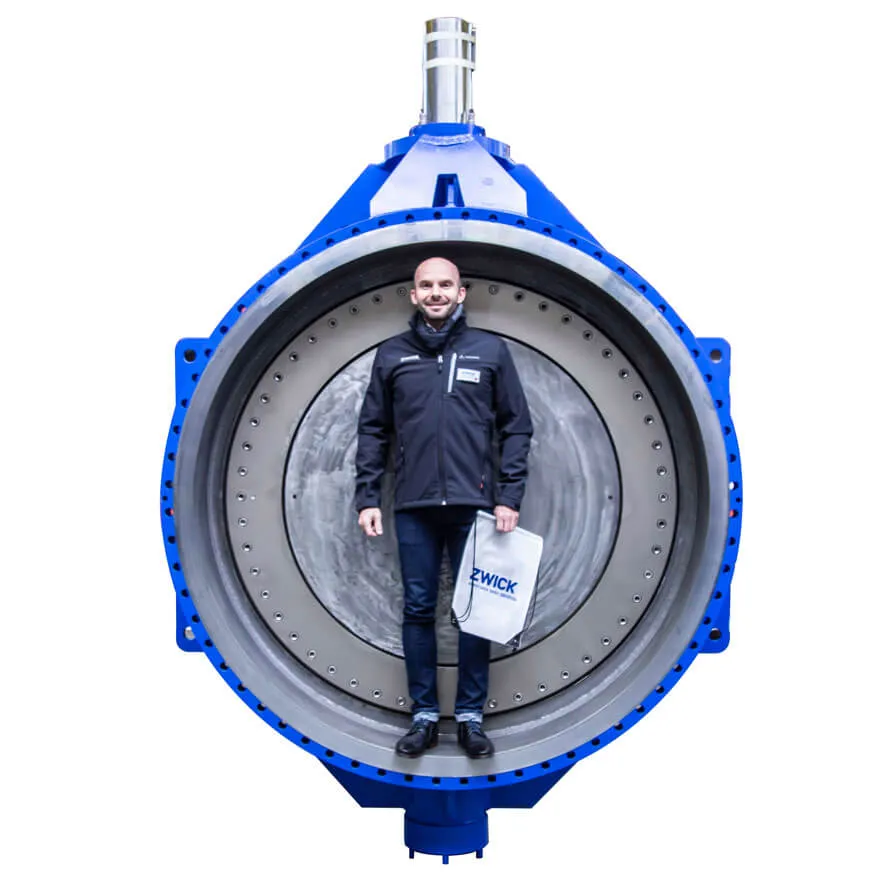 Engineer standing inside large 66 inch Zwick Tri-Con valve, highlighting scale and robust construction